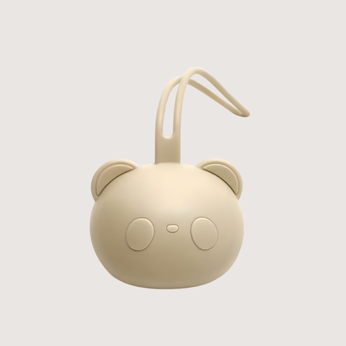 Porte-tétine en silicone beige en forme d’ourson, présenté sur un fond lumineux